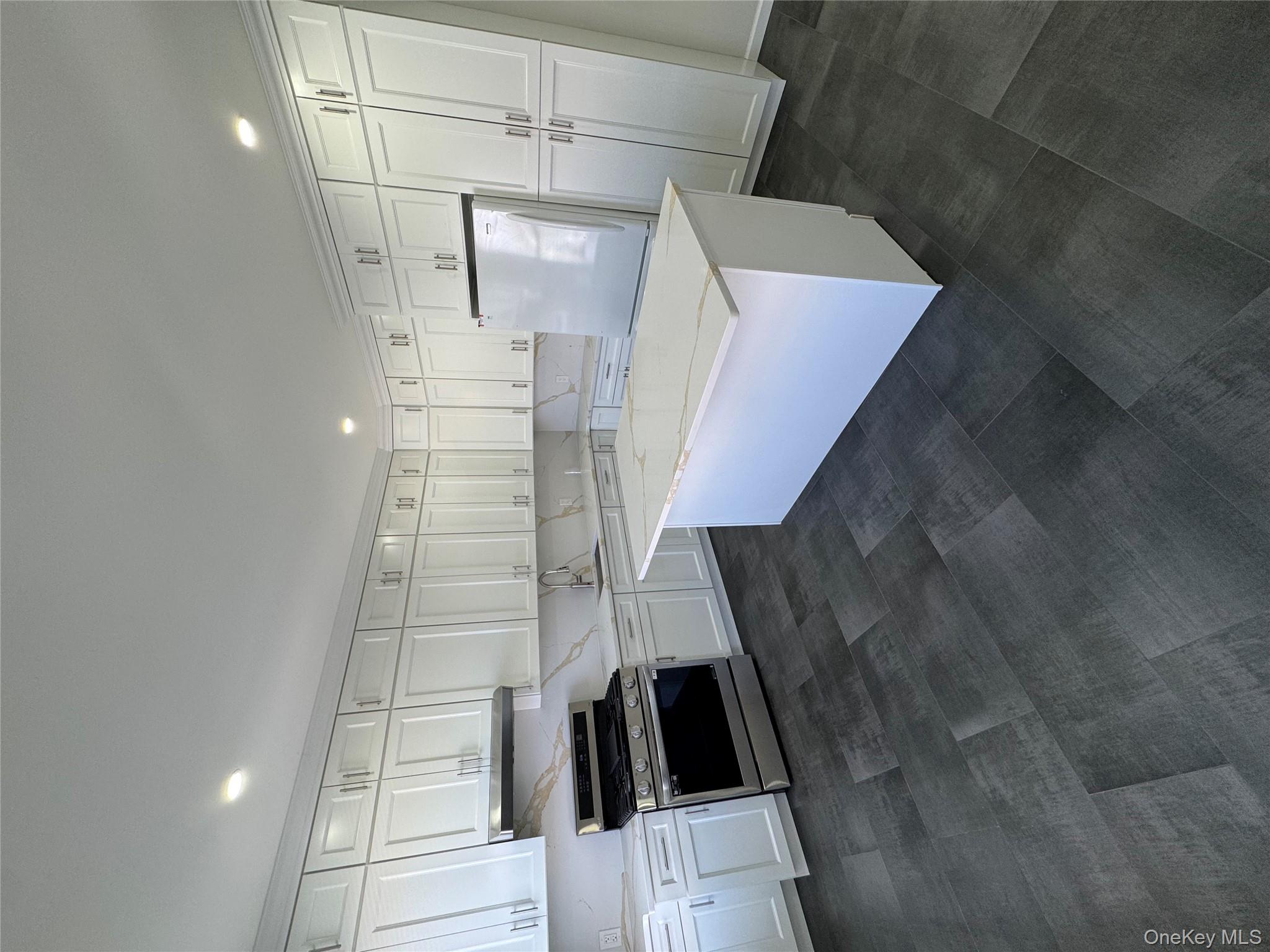 88-36 77th Street Queens, NY 11421 - Photo 6 of 19 a large kitchen with a stove a refrigerator a sink and dishwasher