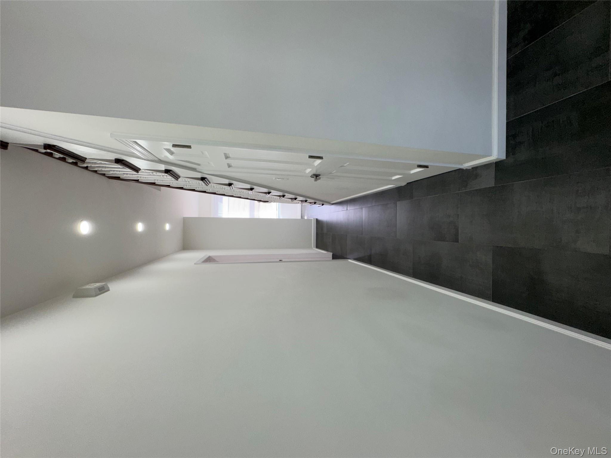 88-36 77th Street Queens, NY 11421 - Photo 8 of 19 a view of a hallway with wooden floor and entryway