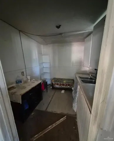 a kitchen with a sink stove and refrigerator