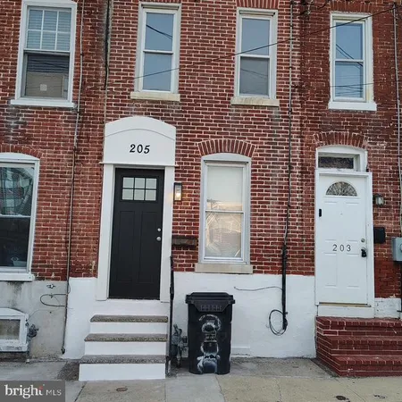 a front view of a house with a bench