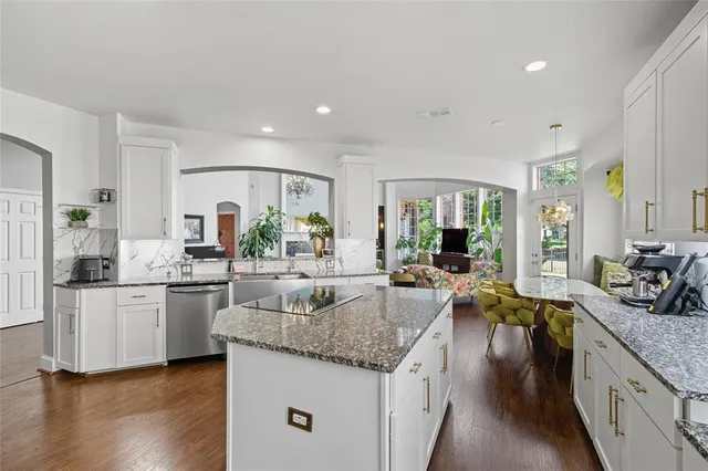 a large kitchen with granite countertop a large counter top furniture and kitchen