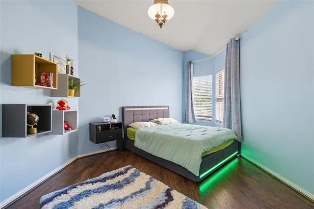 a bedroom with a bed and a chandelier