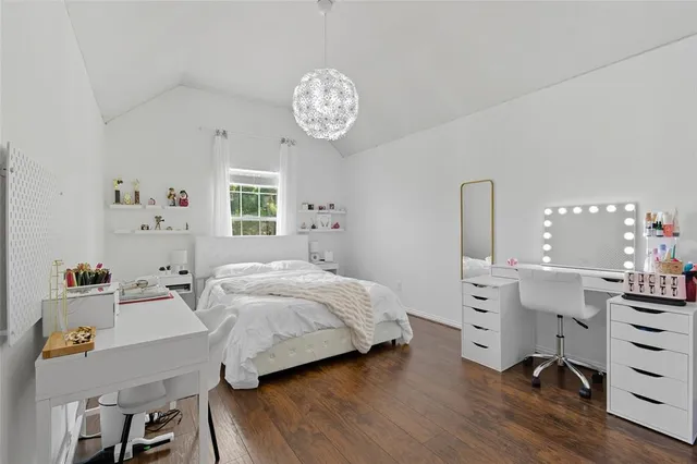 a bedroom with a bed and a table in it