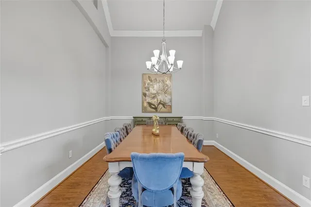 a view of a dining room with furniture and chandelier