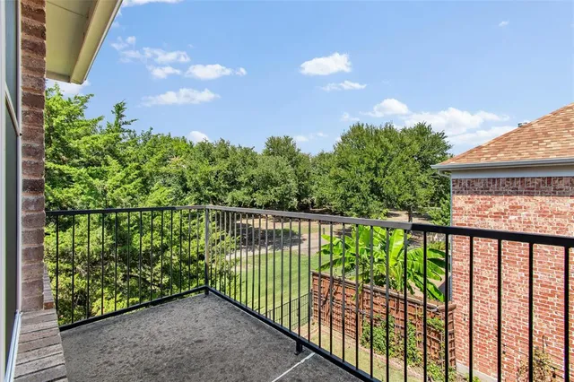 a balcony with trees in front of it