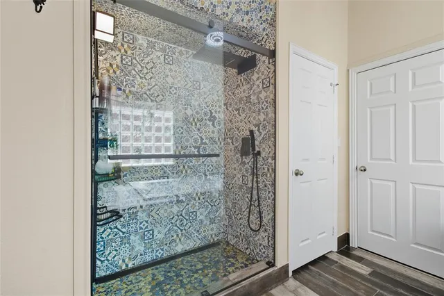 a bathroom with a glass shower door