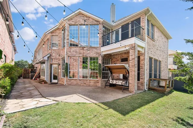 a front view of a building with a garden and plants