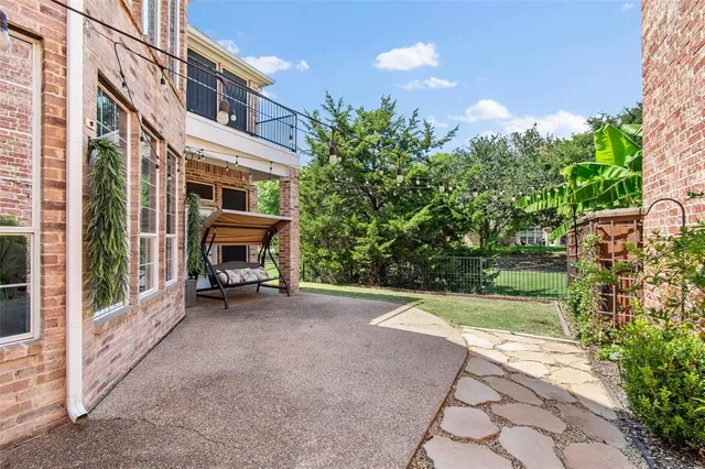 a view of a patio with table and chairs and potted plants