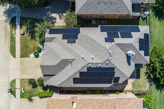 an aerial view of a house with a yard