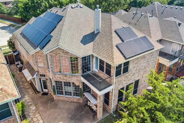 an aerial view of a house with a yard and potted plants