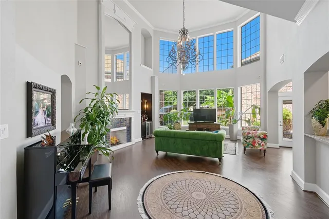 a living room with furniture and a chandelier
