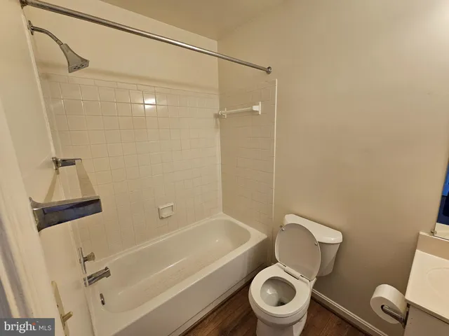 a white toilet and tub next to a bathroom sink
