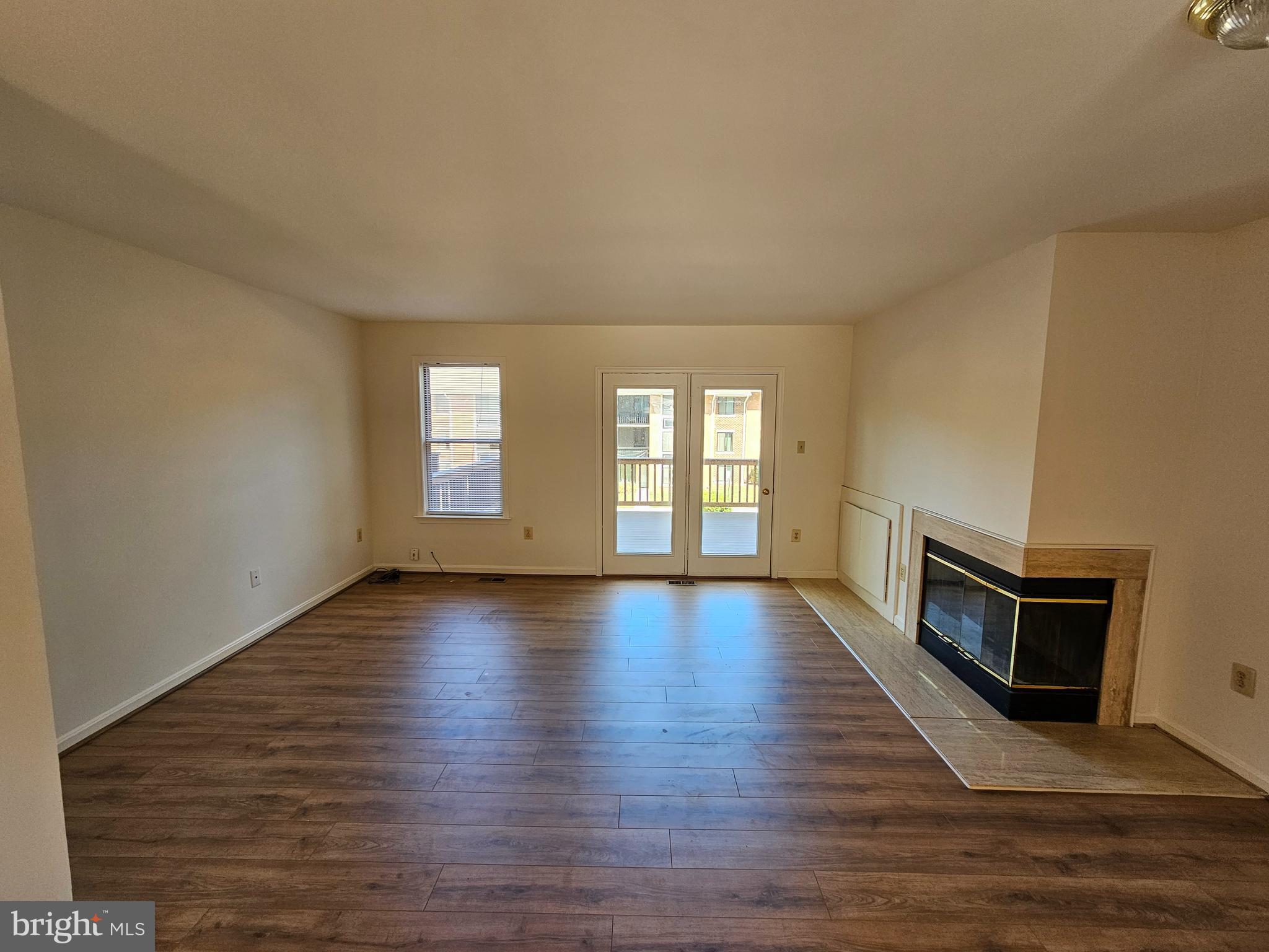 6306 Over See Court Springfield, VA 22152 - Photo 3 of 30 a view of an empty room with a fireplace and a window