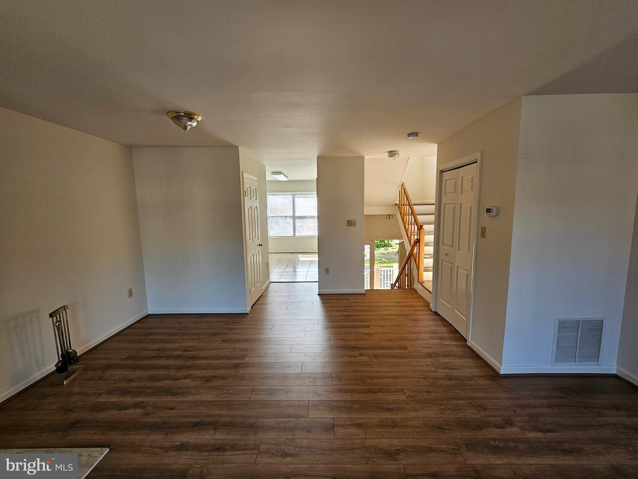 6306 Over See Court Springfield, VA 22152 - Photo 6 of 30 a view of an empty room with wooden floor and a window