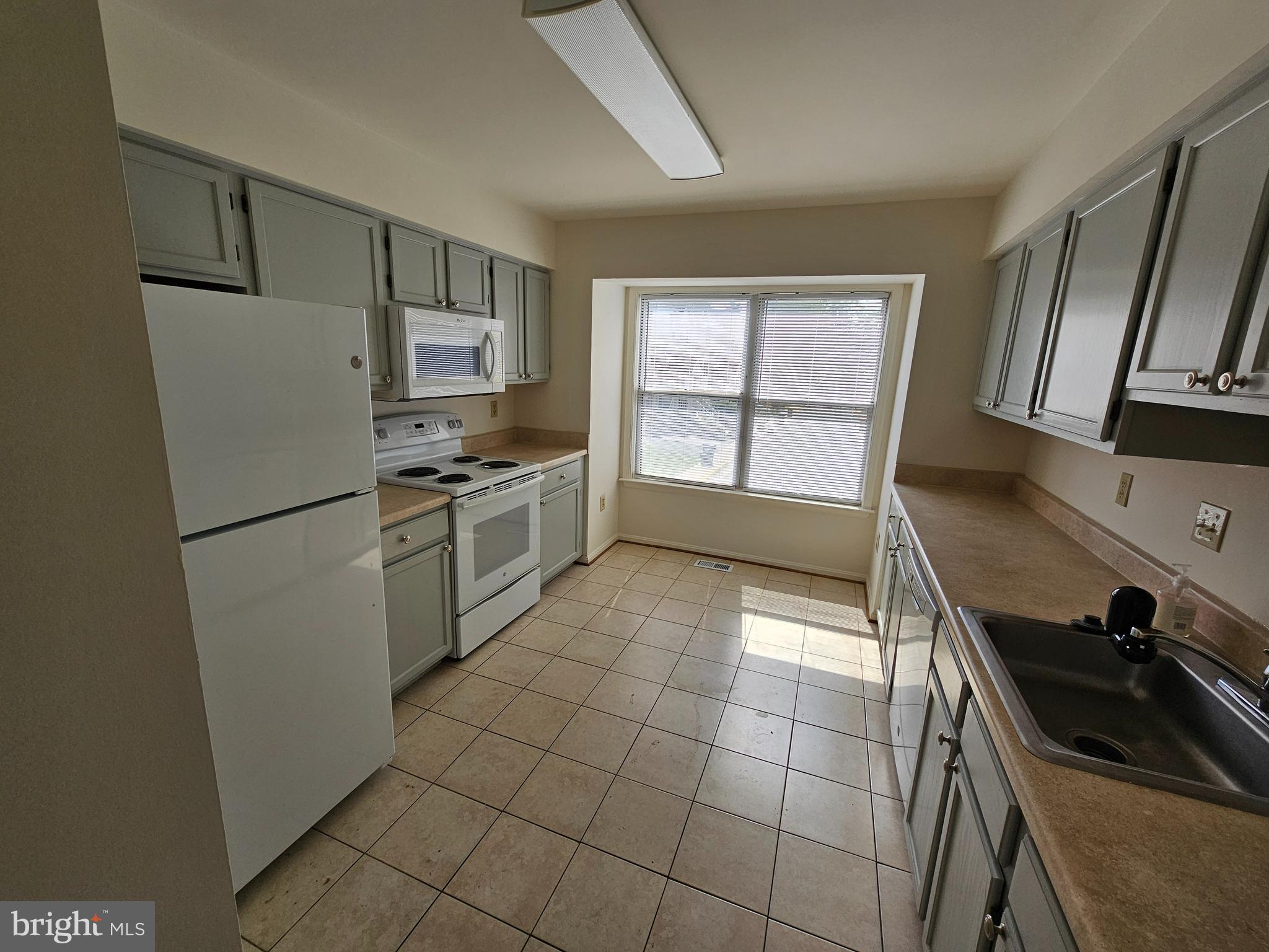 6306 Over See Court Springfield, VA 22152 - Photo 7 of 30 a kitchen with granite countertop a sink a stove a refrigerator and cabinets