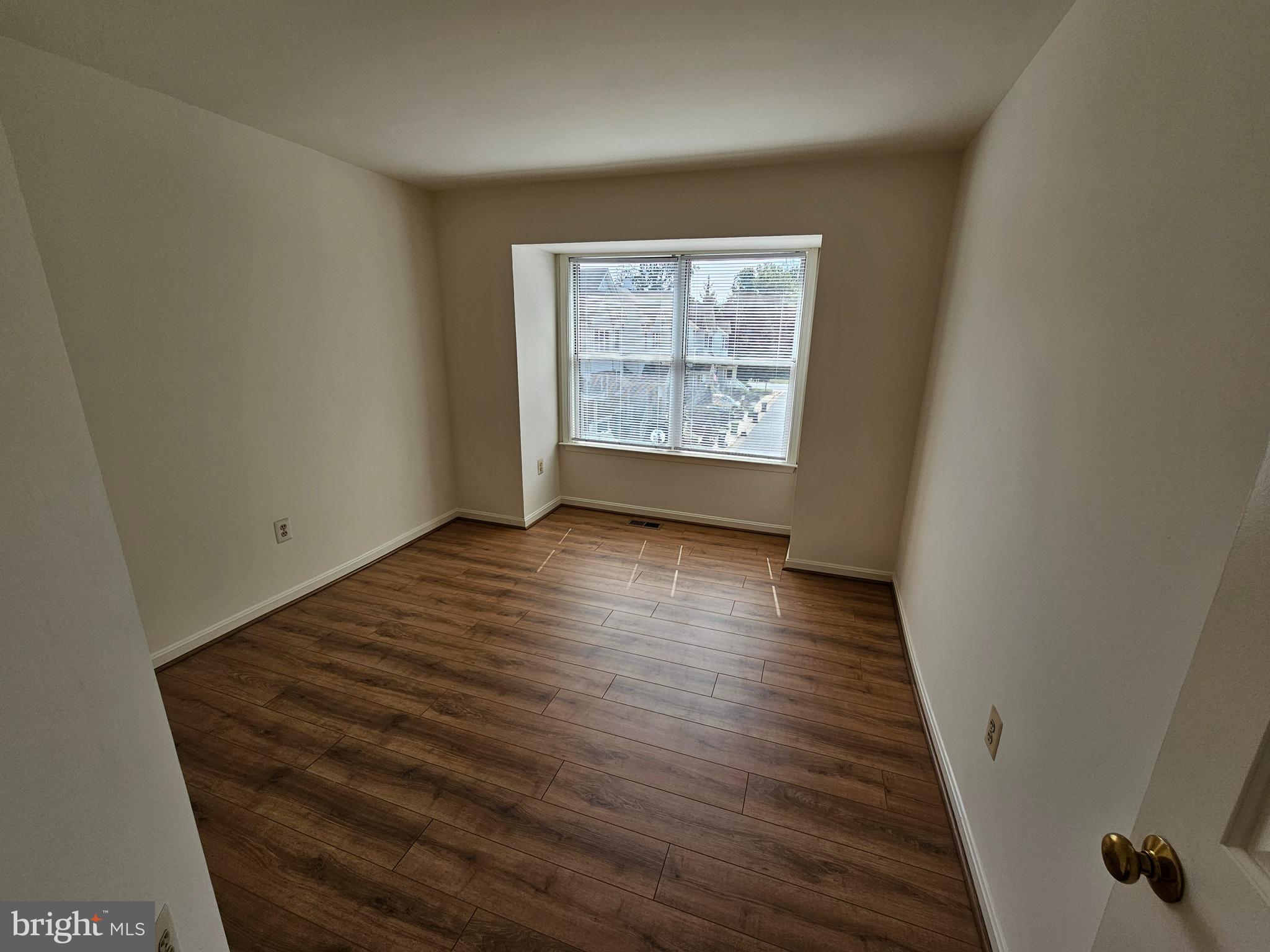 6306 Over See Court Springfield, VA 22152 - Photo 9 of 30 a view of an empty room with wooden floor and a window