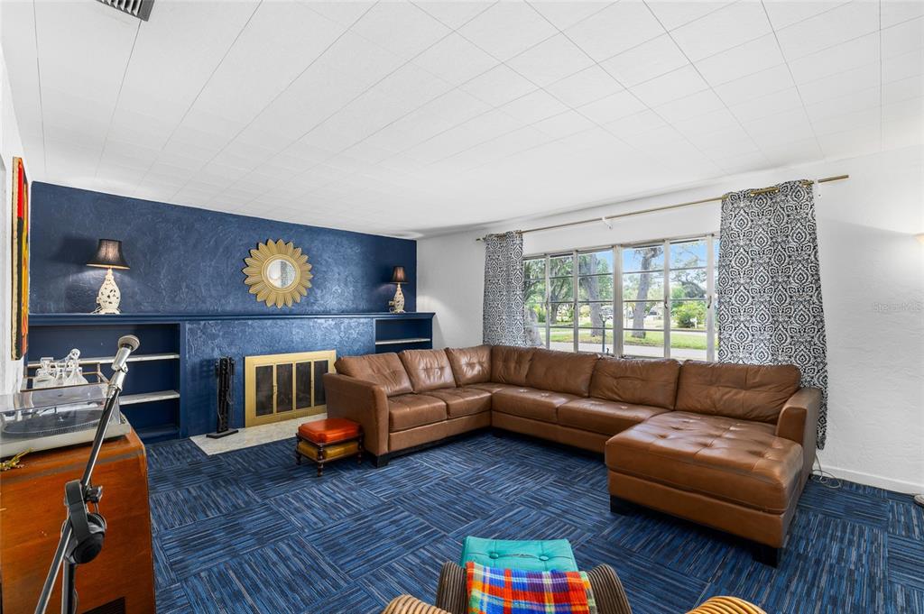 2027 Pinecrest Way Clearwater, FL 33755 - Photo 11 of 47 a living room with furniture and a fireplace