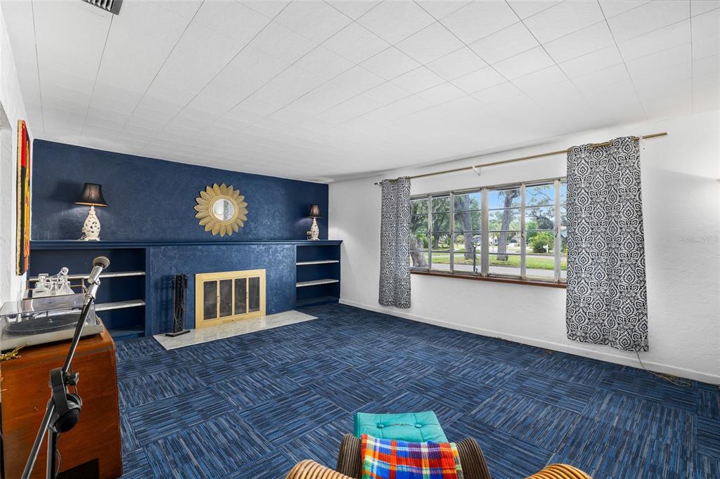 2027 Pinecrest Way Clearwater, FL 33755 - Photo 12 of 47 a living room with furniture and a fireplace