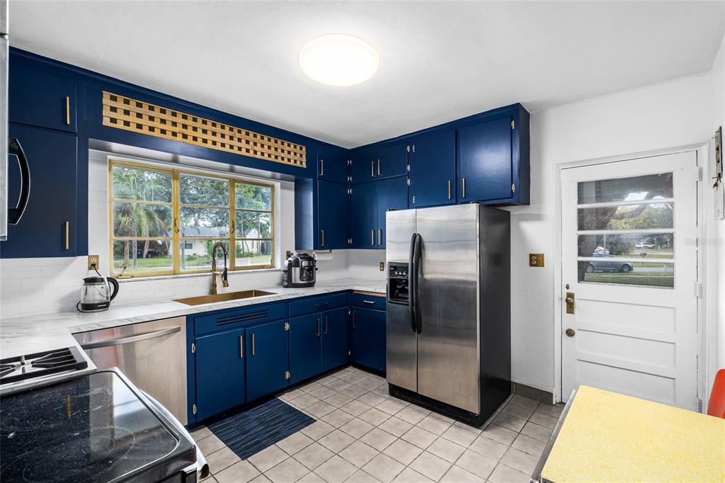2027 Pinecrest Way Clearwater, FL 33755 - Photo 14 of 47 a kitchen with stainless steel appliances granite countertop a refrigerator and a sink