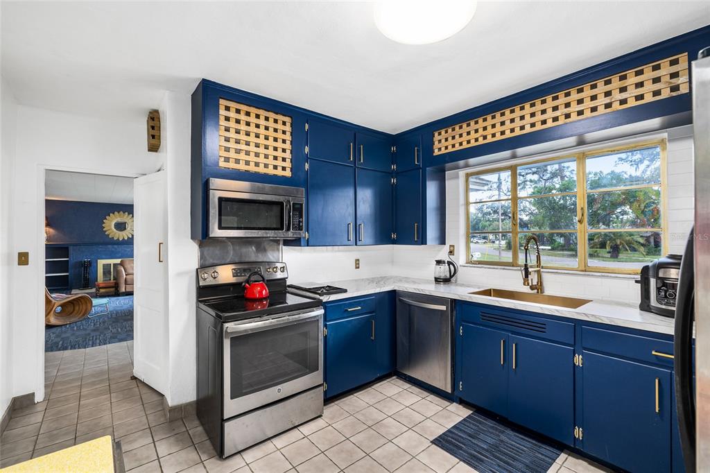 2027 Pinecrest Way Clearwater, FL 33755 - Photo 16 of 47 a kitchen with a sink and a stove top oven