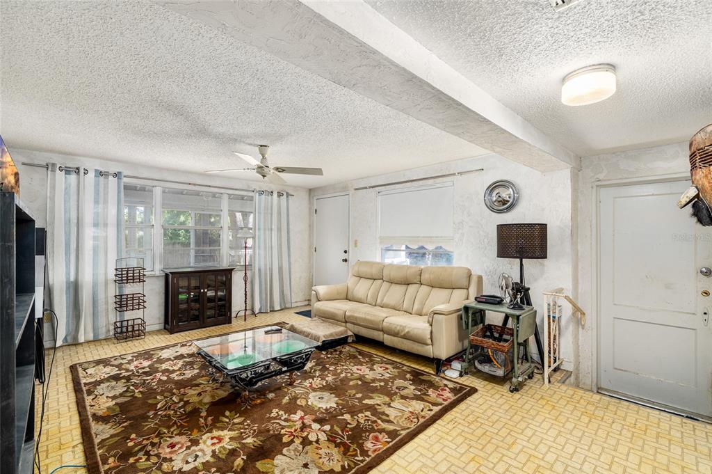 2027 Pinecrest Way Clearwater, FL 33755 - Photo 17 of 47 a living room with furniture rug and a fireplace