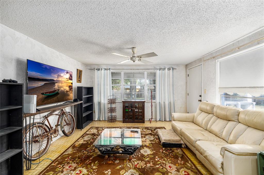 2027 Pinecrest Way Clearwater, FL 33755 - Photo 18 of 47 a living room with furniture a fireplace and a flat screen tv
