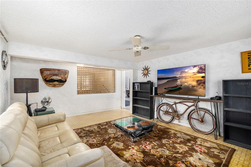 2027 Pinecrest Way Clearwater, FL 33755 - Photo 19 of 47 a living room with furniture a flat screen tv and a window