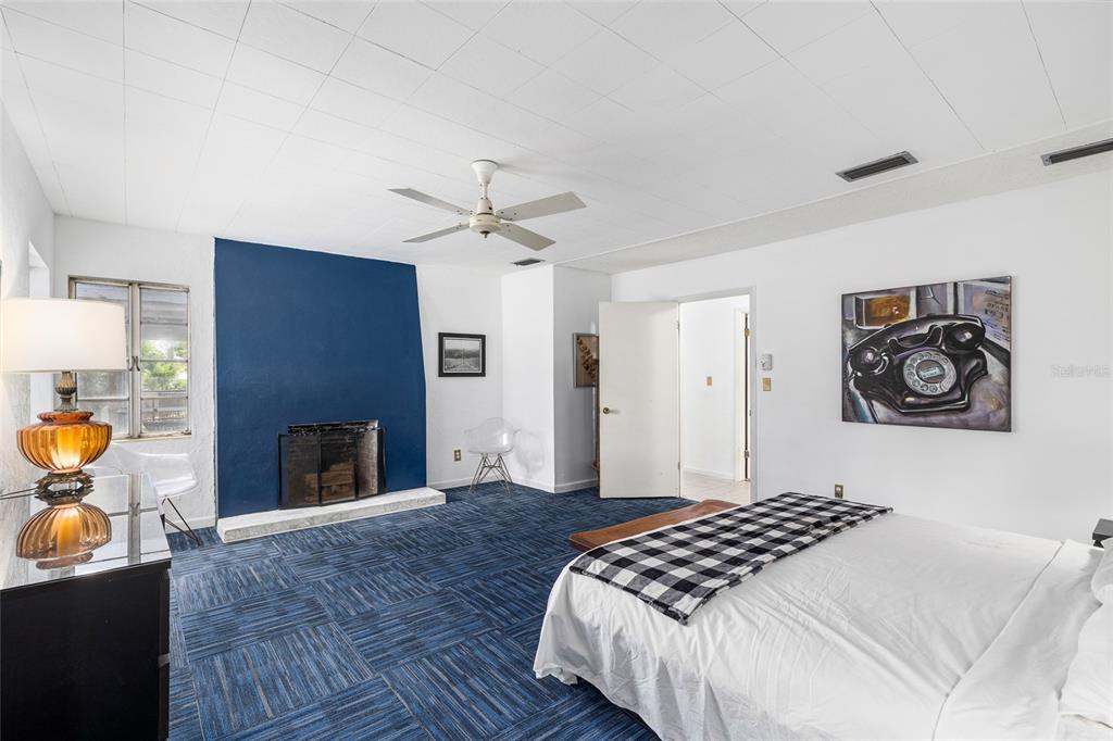 2027 Pinecrest Way Clearwater, FL 33755 - Photo 20 of 47 a bedroom with a bed and a chandelier