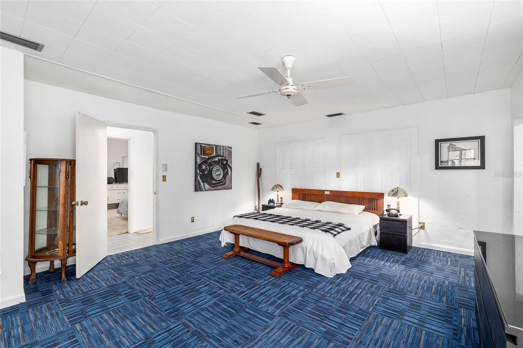 2027 Pinecrest Way Clearwater, FL 33755 - Photo 22 of 47 a bedroom with a bed and a chandelier