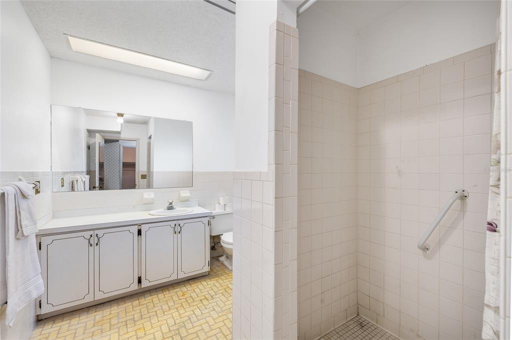 2027 Pinecrest Way Clearwater, FL 33755 - Photo 25 of 47 a view of a bathroom with a sink and mirror