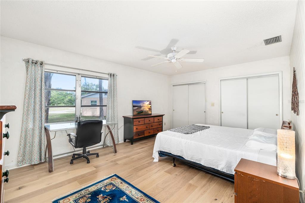 2027 Pinecrest Way Clearwater, FL 33755 - Photo 27 of 47 a bedroom with a bed a desk and chair