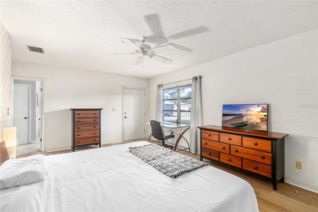 2027 Pinecrest Way Clearwater, FL 33755 - Photo 28 of 47 a bedroom with a bed and a dresser in it