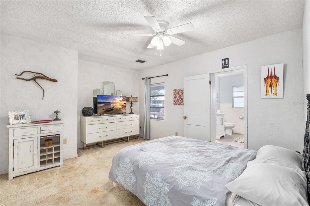 2027 Pinecrest Way Clearwater, FL 33755 - Photo 31 of 47 a bedroom with a bed and a chandelier