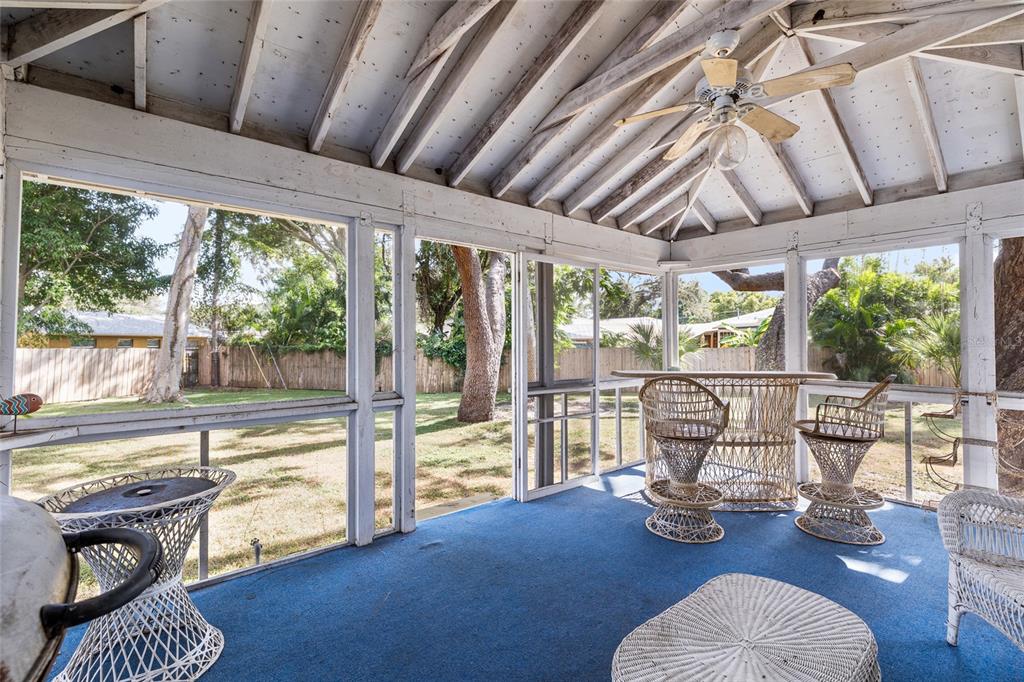 2027 Pinecrest Way Clearwater, FL 33755 - Photo 36 of 47 a living room with furniture floor to ceiling windows and wooden floor