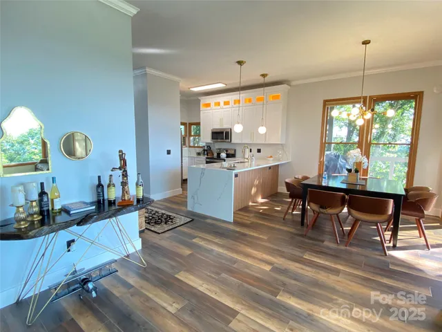a kitchen with a dining table chairs stove and kitchen view