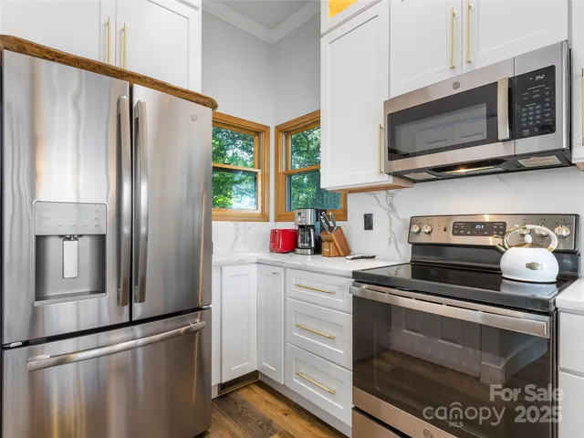 a kitchen with stainless steel appliances a refrigerator stove and microwave