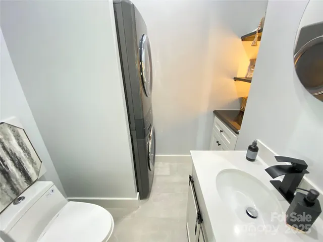 a bathroom with a sink and mirror with toilet