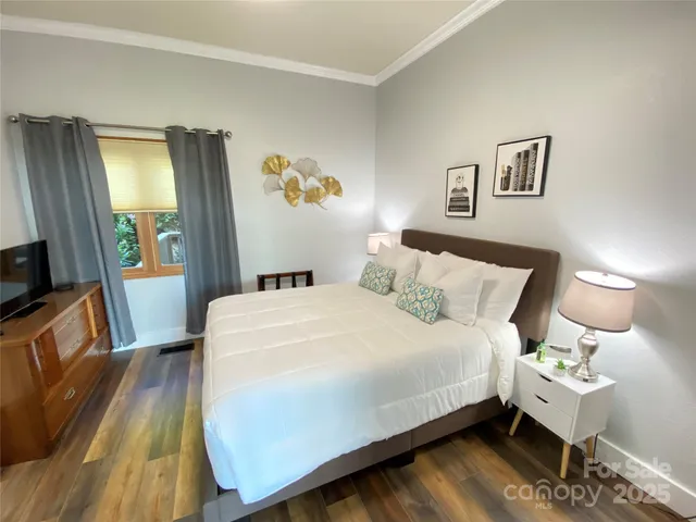 a large bed sitting in a bedroom next to a window