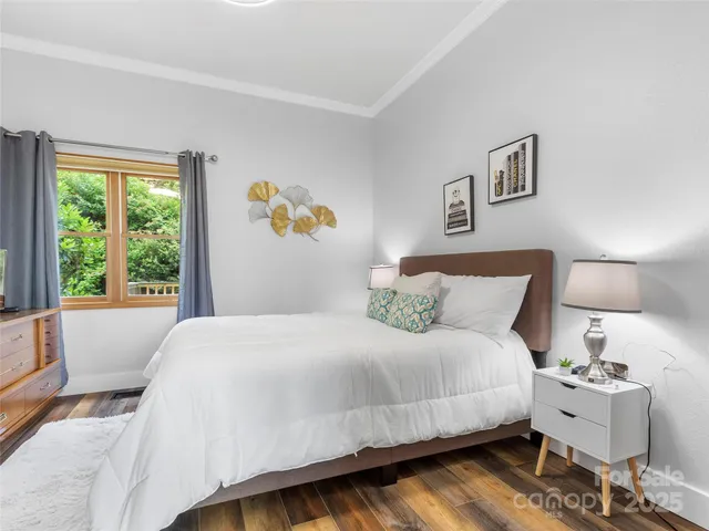 a bedroom with a bed and a large window