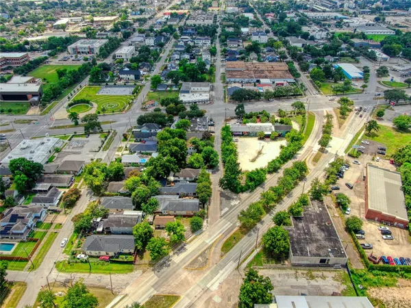 an aerial view of residential houses with outdoor space and swimming pool