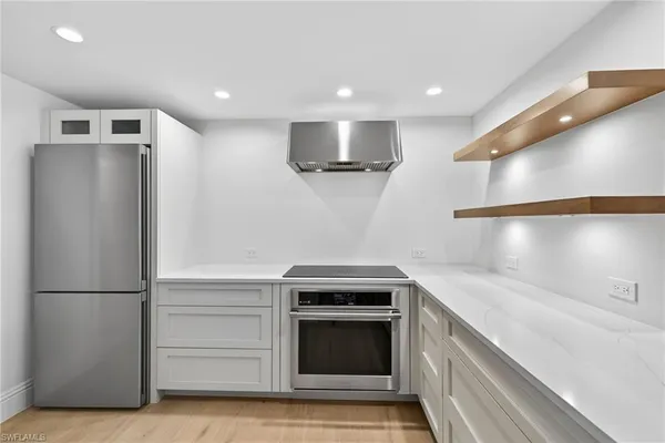 a kitchen with a refrigerator and a sink