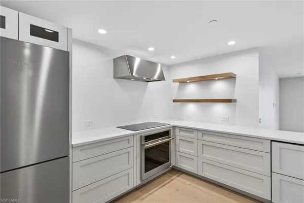 a kitchen with a refrigerator and a sink