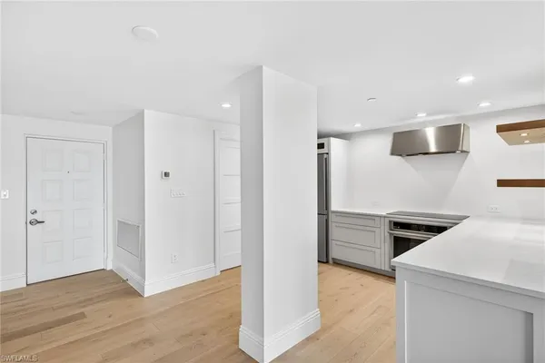 a view of a kitchen with a sink and a refrigerator