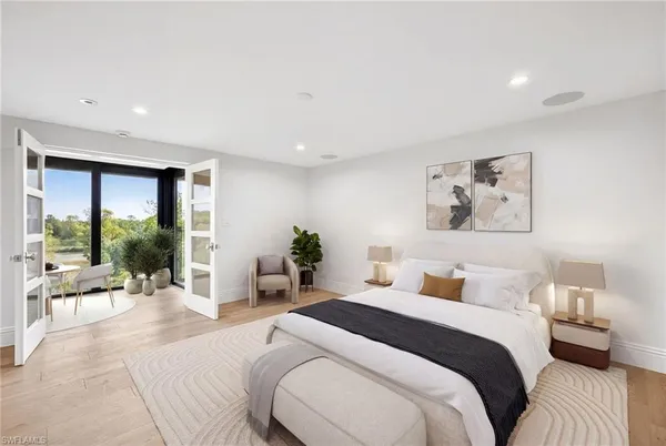 a bedroom with a large bed and a large window