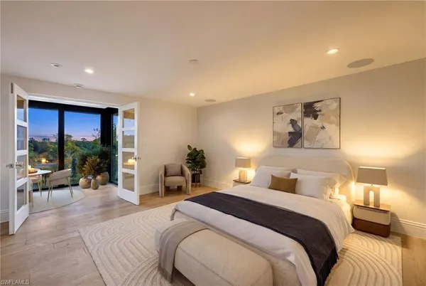 a bedroom with a large bed and a large window