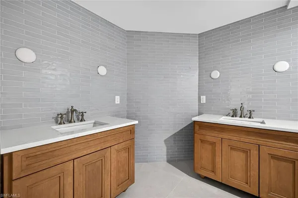 a bathroom with a double vanity sink and mirror