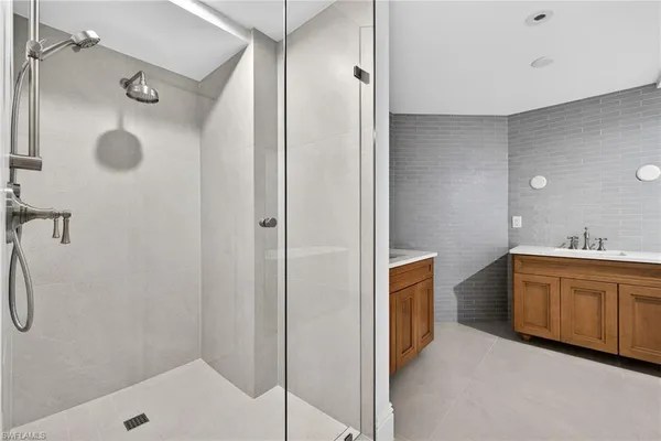 a bathroom with a tub sink and mirror
