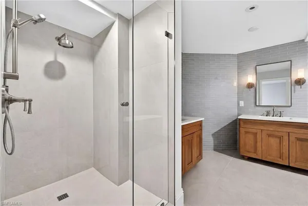 a bathroom with a tub sink and mirror
