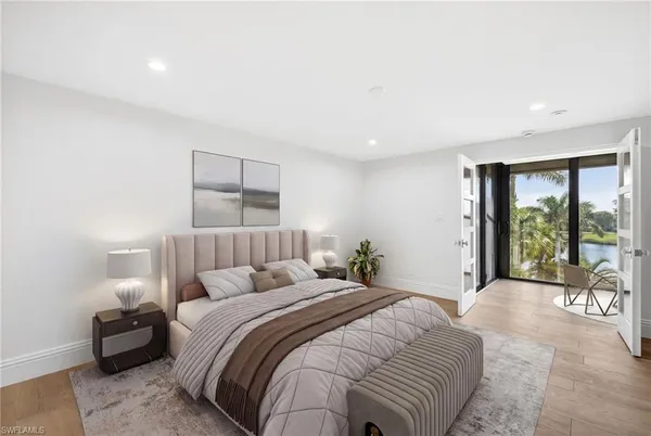 a bedroom with a large bed and a large window