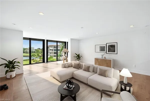 a living room with furniture and a large window with outer view